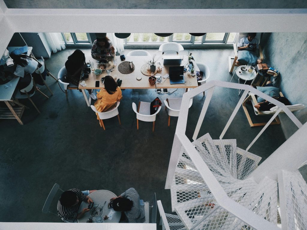 Group of People Sitting Around Table Inside Room